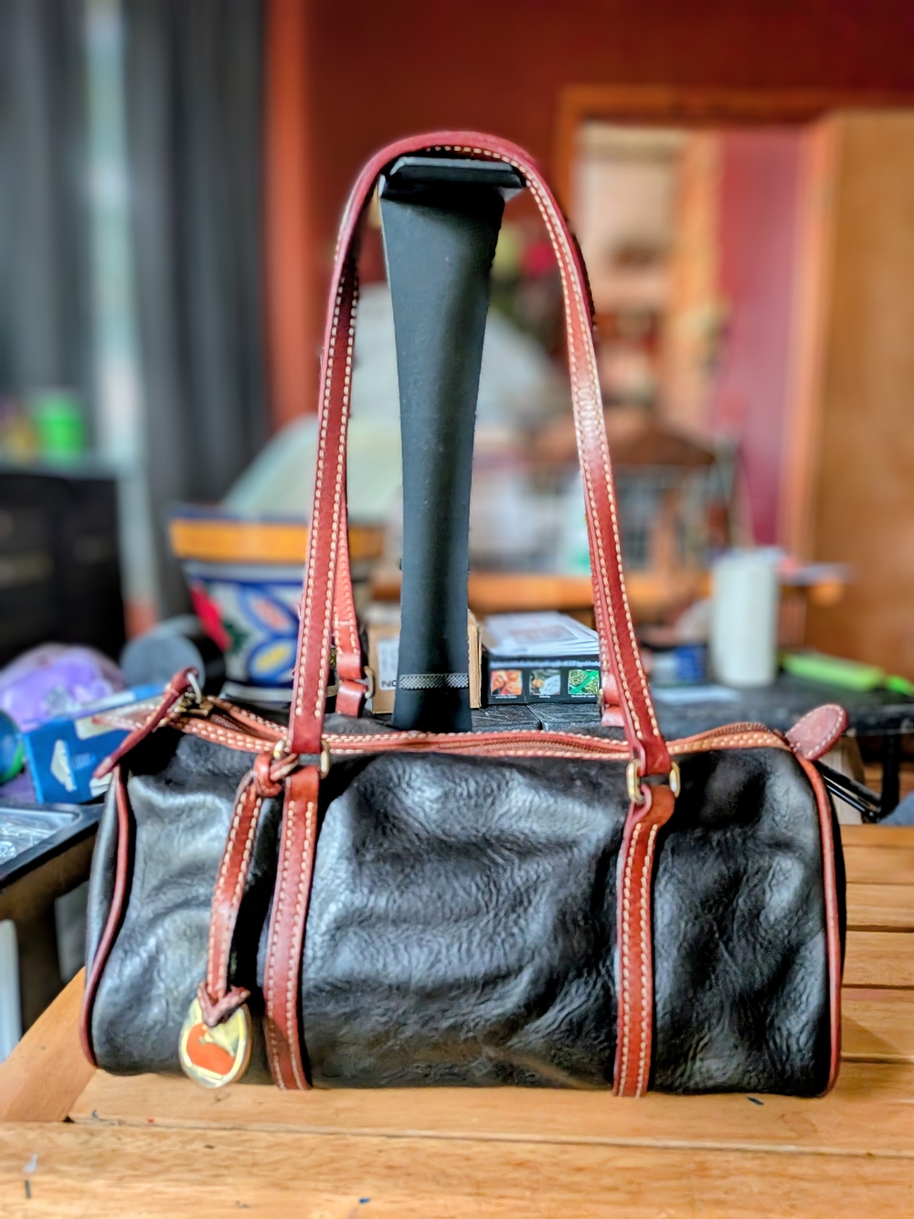 Dooney & Bourke Black Leather Barrel Bag with Brown Trim and Gold Hardware